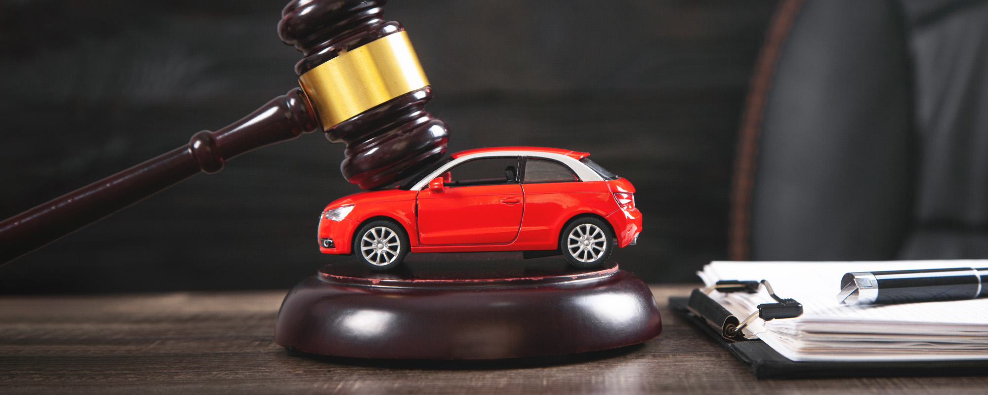 Judge gavel over car and document